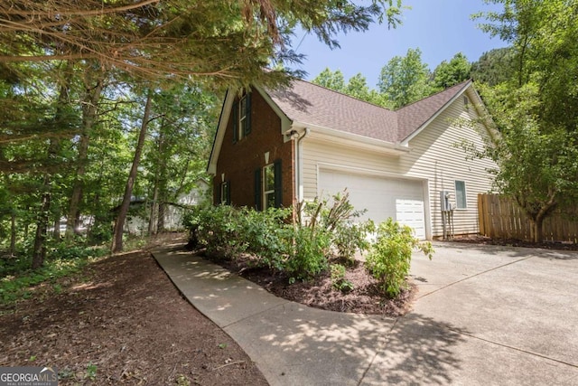 5533 Rose Ridge Ct, Flowery Branch, GA 30542 - view of side of home with a garage, driveway, and a shingled roof