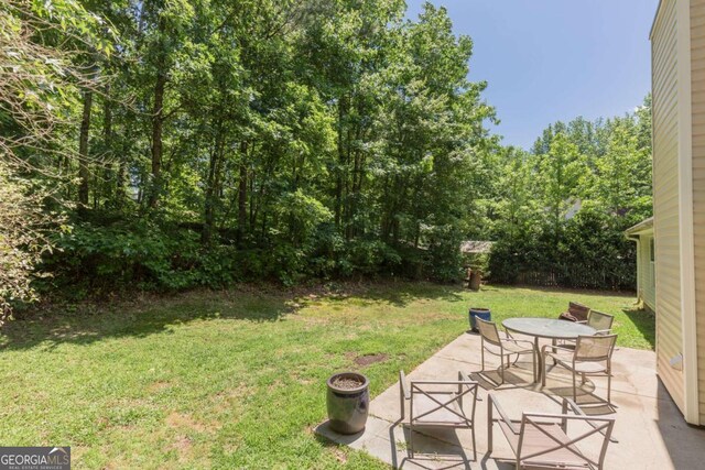 5533 Rose Ridge Ct, Flowery Branch, GA 30542 - view of grassy yard featuring a patio area and outdoor dining space