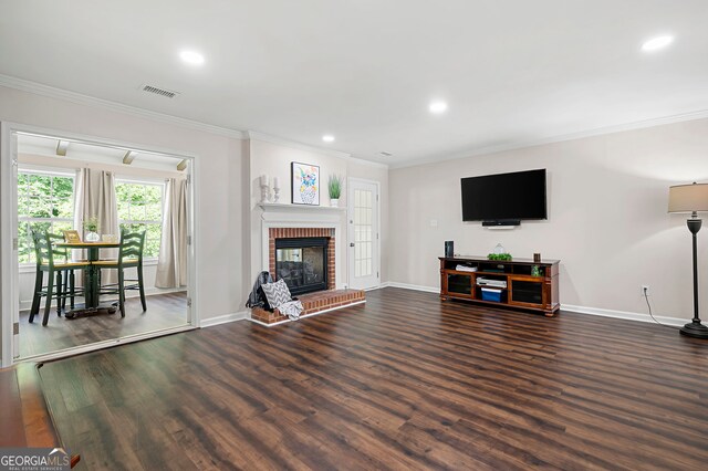 1223 Whitlock Ridge Dr SW, Marietta, GA 30064 - living room with crown molding, wood finished floors, recessed lighting, and a brick fireplace