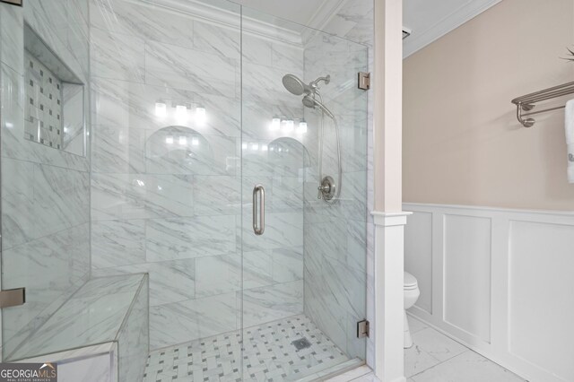 1223 Whitlock Ridge Dr SW, Marietta, GA 30064 - bathroom featuring marble look tiles, ornamental molding, a shower stall, a wainscoted wall, and a decorative wall