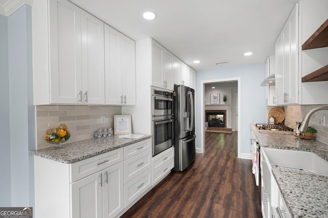 1223 Whitlock Ridge Dr SW, Marietta, GA 30064 - kitchen featuring appliances with stainless steel finishes, open shelves, dark wood-type flooring, tasteful backsplash, and white cabinets