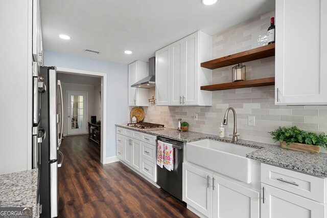 1223 Whitlock Ridge Dr SW, Marietta, GA 30064 - kitchen with appliances with stainless steel finishes, wall chimney range hood, open shelves, white cabinetry, and decorative backsplash