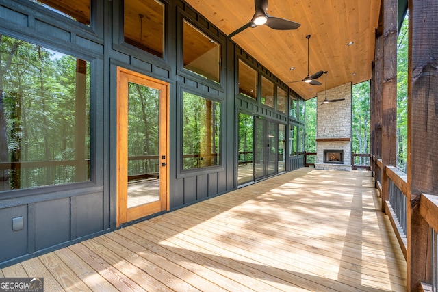 221 Goldmine Rd, Morganton, GA 30560 - unfurnished sunroom with an outdoor stone fireplace, a ceiling fan, healthy amount of natural light, and lofted ceiling
