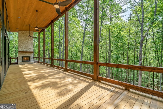 221 Goldmine Rd, Morganton, GA 30560 - wooden terrace with a stone fireplace, ceiling fan, and a view of trees