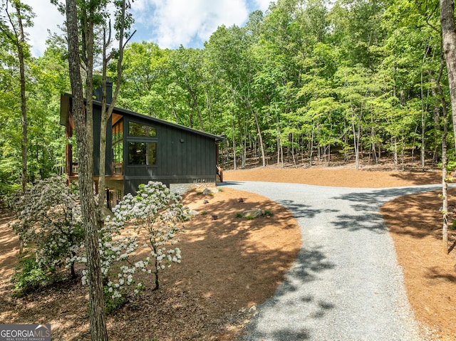 221 Goldmine Rd, Morganton, GA 30560 - view of side of property featuring board and batten siding, a view of trees, and curved driveway