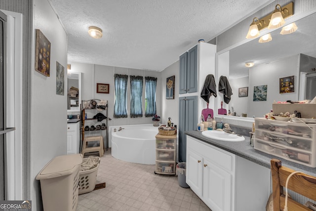 3085 Pea Ridge Rd, Cornelia, GA 30531 - full bath featuring a garden tub, vanity, a textured ceiling, and tile patterned floors