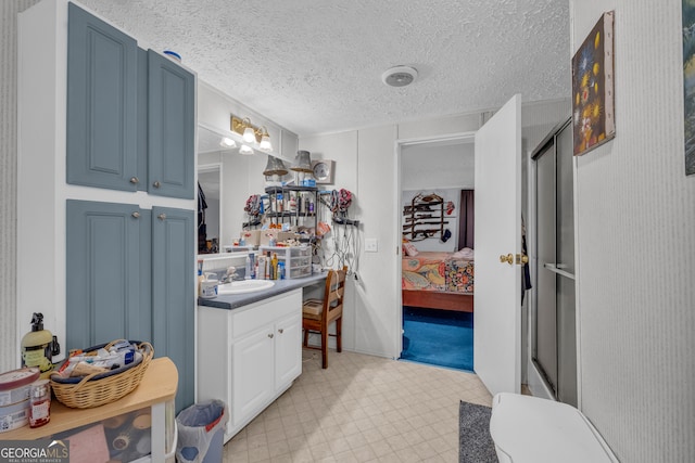 3085 Pea Ridge Rd, Cornelia, GA 30531 - full bathroom featuring vanity, connected bathroom, tile patterned floors, an enclosed shower, and a textured ceiling