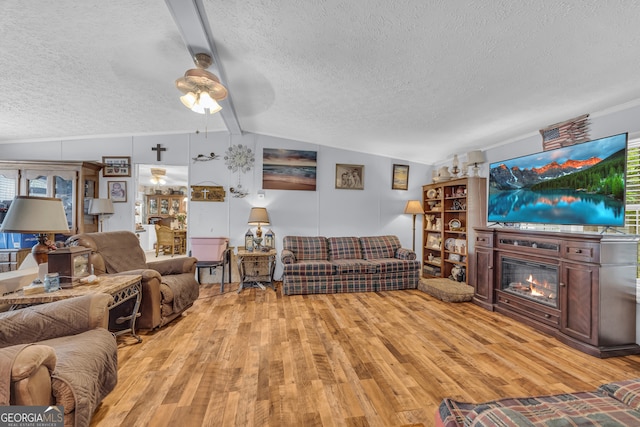 3085 Pea Ridge Rd, Cornelia, GA 30531 - living area with a textured ceiling, light wood-style flooring, ceiling fan, and a glass covered fireplace