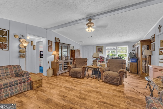 3085 Pea Ridge Rd, Cornelia, GA 30531 - living room with a textured ceiling, light wood finished floors, a ceiling fan, and beamed ceiling