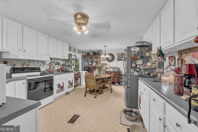 3085 Pea Ridge Rd, Cornelia, GA 30531 - kitchen with white electric range oven, under cabinet range hood, a ceiling fan, dark countertops, and white cabinetry
