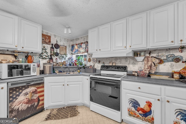 3085 Pea Ridge Rd, Cornelia, GA 30531 - kitchen with range with electric cooktop, dishwashing machine, a sink, custom exhaust hood, and white cabinetry