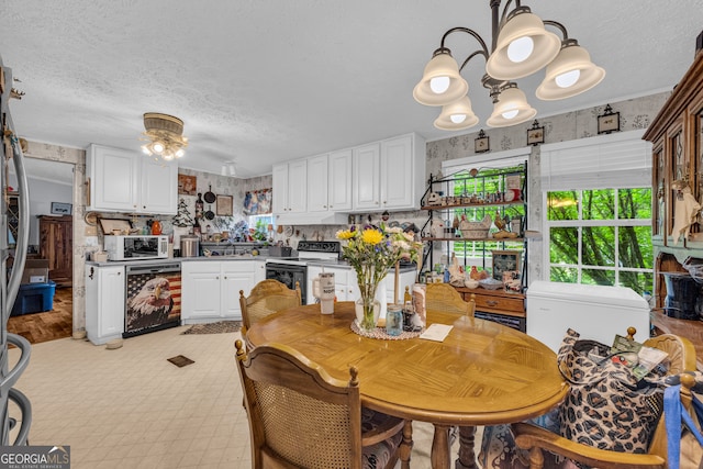 3085 Pea Ridge Rd, Cornelia, GA 30531 - kitchen featuring dishwasher, electric range, a chandelier, a textured ceiling, and white cabinetry