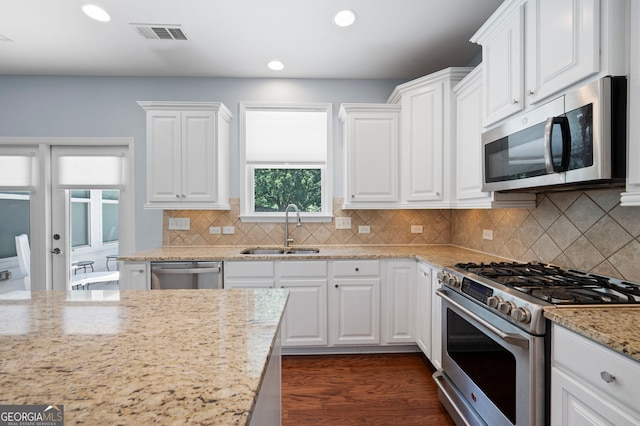 130 Bevington Ln, Woodstock, GA 30188 - kitchen featuring stainless steel appliances, a sink, white cabinets, recessed lighting, and light stone countertops
