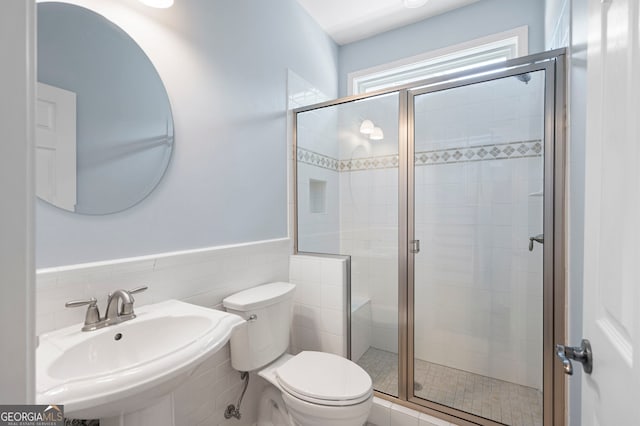 130 Bevington Ln, Woodstock, GA 30188 - bathroom with toilet, a sink, tile walls, a stall shower, and wainscoting