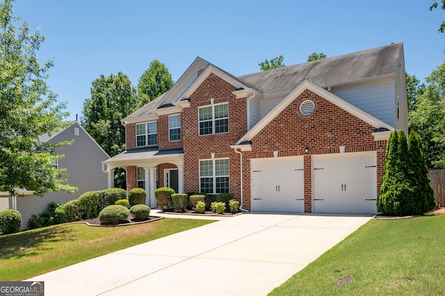 130 Bevington Ln, Woodstock, GA 30188 - traditional-style home featuring brick siding, a garage, driveway, and a front lawn
