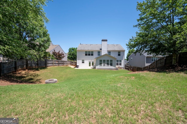130 Bevington Ln, Woodstock, GA 30188 - back of property featuring a chimney and an outdoor fire pit