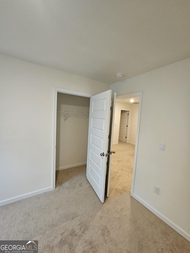 190 Hampton Cir, Mcdonough, GA 30253 - unfurnished bedroom featuring carpet floors, baseboards, and a closet