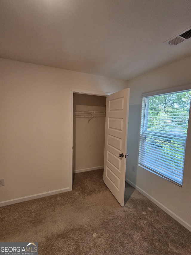 190 Hampton Cir, Mcdonough, GA 30253 - unfurnished bedroom with carpet flooring, baseboards, and a closet