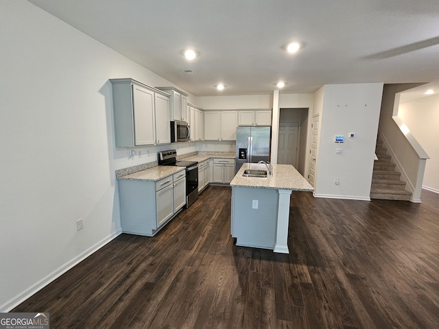190 Hampton Cir, Mcdonough, GA 30253 - kitchen featuring stainless steel appliances, a sink, baseboards, dark wood-type flooring, and light stone countertops