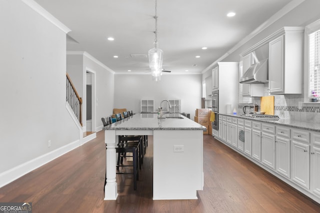 132 Shellbark Dr, Mcdonough, GA 30252 - kitchen featuring a kitchen bar, recessed lighting, an island with sink, ceiling fan, and appliances with stainless steel finishes