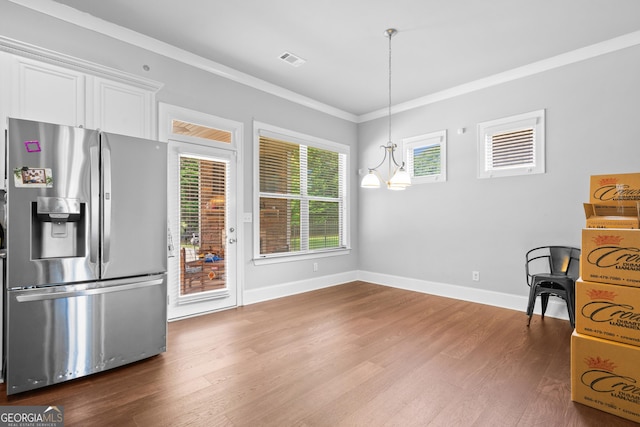 132 Shellbark Dr, Mcdonough, GA 30252 - unfurnished dining area featuring dark wood-style flooring, crown molding, and a chandelier