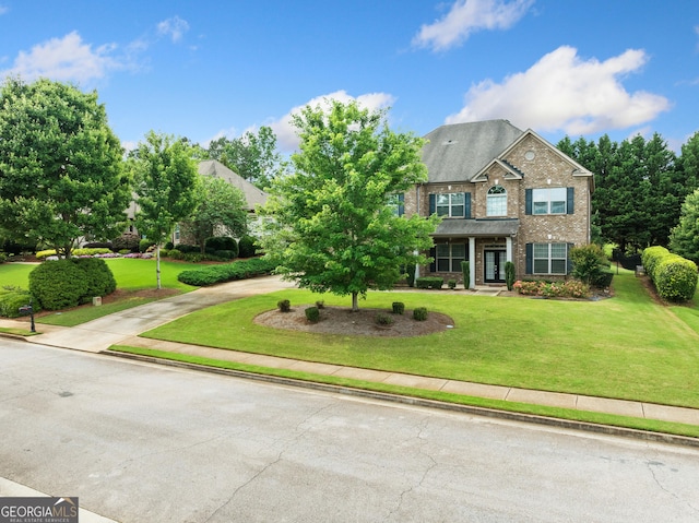 132 Shellbark Dr, Mcdonough, GA 30252 - view of front facade with brick siding, a front lawn, and curved driveway