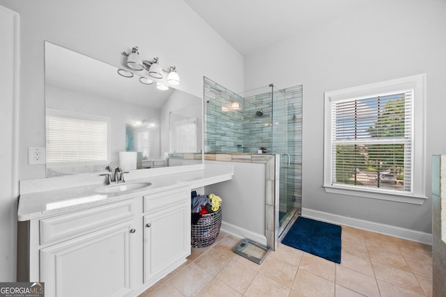 132 Shellbark Dr, Mcdonough, GA 30252 - bathroom featuring a shower stall, vanity, tile patterned flooring, and vaulted ceiling
