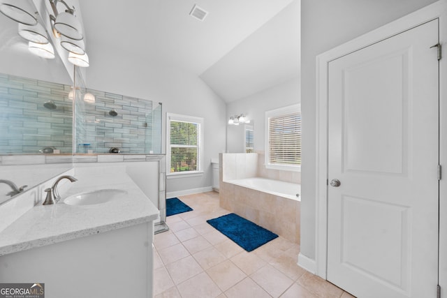 132 Shellbark Dr, Mcdonough, GA 30252 - full bathroom with tile patterned flooring, vaulted ceiling, vanity, a garden tub, and a tile shower