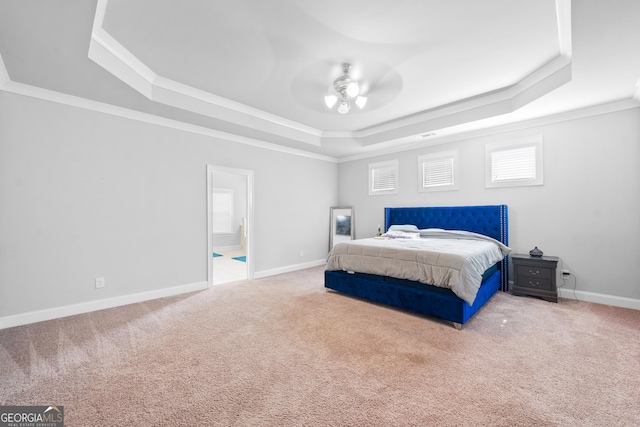 132 Shellbark Dr, Mcdonough, GA 30252 - carpeted bedroom featuring a raised ceiling, crown molding, ensuite bathroom, and a ceiling fan
