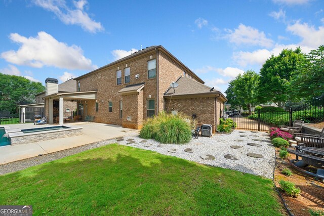 132 Shellbark Dr, Mcdonough, GA 30252 - rear view of property with brick siding, a patio, an in-ground hot tub, and a chimney