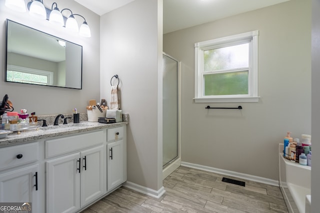 520 Campbell Rd, Cedartown, GA 30125 - bathroom with vanity, a stall shower, wood finished floors, and baseboards