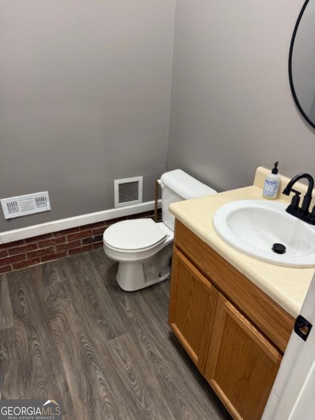 520 Campbell Rd, Cedartown, GA 30125 - half bathroom featuring toilet, vanity, and wood finished floors