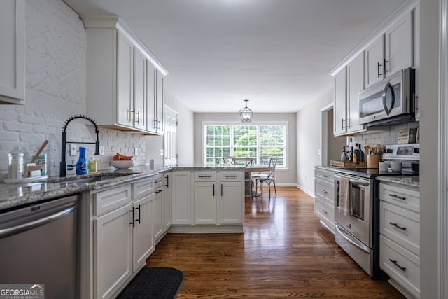 520 Campbell Rd, Cedartown, GA 30125 - kitchen featuring appliances with stainless steel finishes, dark wood finished floors, a sink, and decorative backsplash