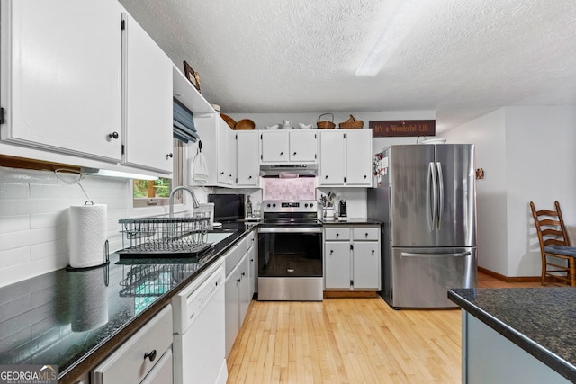 349 Campground Rd, Mcdonough, GA 30253 - kitchen featuring stainless steel appliances, under cabinet range hood, light wood-style flooring, a textured ceiling, and white cabinets
