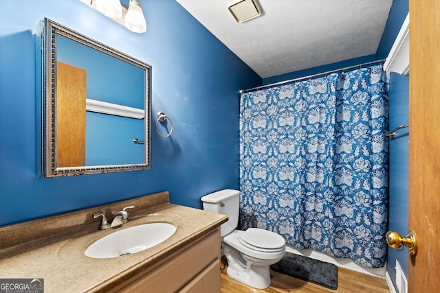 349 Campground Rd, Mcdonough, GA 30253 - full bathroom with toilet, vanity, a textured ceiling, wood finished floors, and curtained shower
