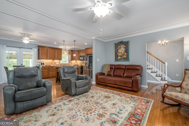 724 Fish Cove Rd, Blairsville, GA 30512 - living area with ceiling fan, light wood-style flooring, ornamental molding, baseboards, and a chandelier