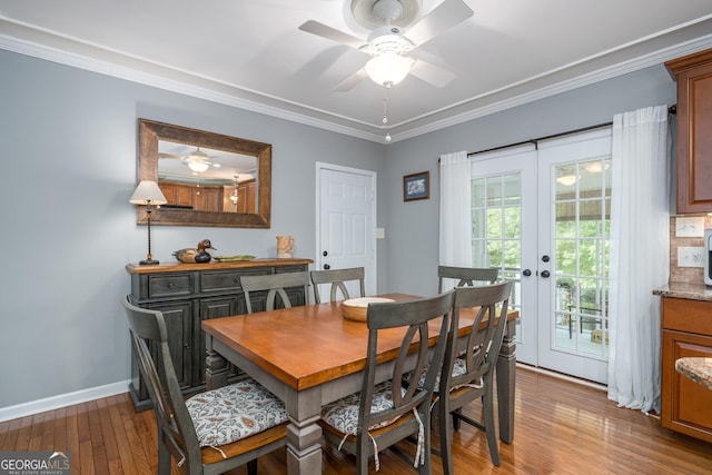 724 Fish Cove Rd, Blairsville, GA 30512 - dining room with wood-type flooring, french doors, a ceiling fan, ornamental molding, and baseboards