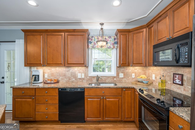 724 Fish Cove Rd, Blairsville, GA 30512 - kitchen with black appliances, a sink, brown cabinets, light stone counters, and crown molding