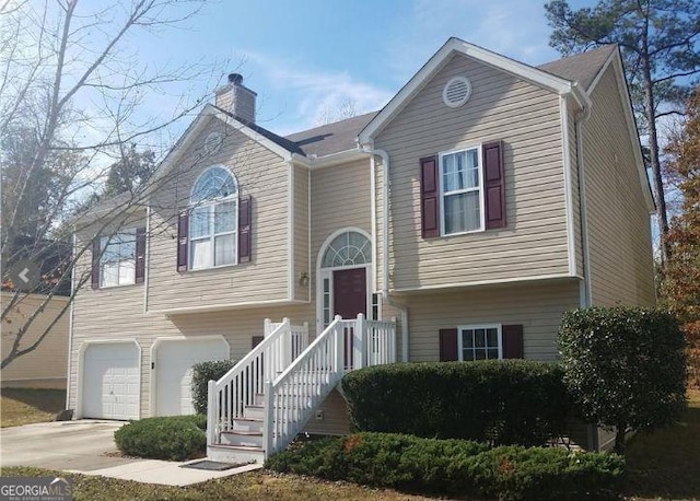 5709 Newnan Cir, Austell, GA 30106 - split foyer home with an attached garage, a chimney, and driveway