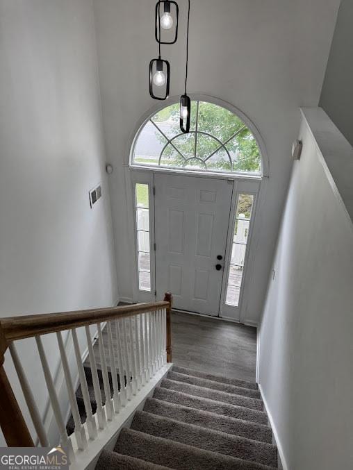 5709 Newnan Cir, Austell, GA 30106 - foyer featuring stairs, a towering ceiling, baseboards, and wood finished floors