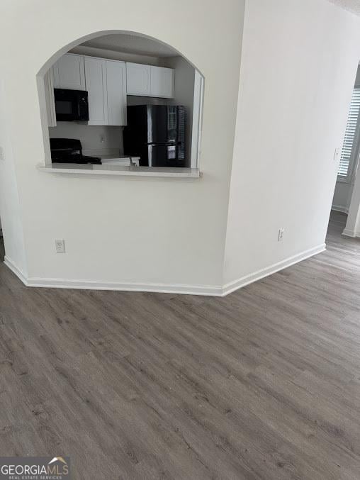 5709 Newnan Cir, Austell, GA 30106 - kitchen with black appliances, baseboards, dark wood finished floors, and white cabinets