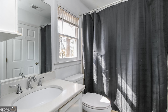 387 Colvin Dr, Locust Grove, GA 30248 - bathroom with toilet, vanity, and a shower with shower curtain