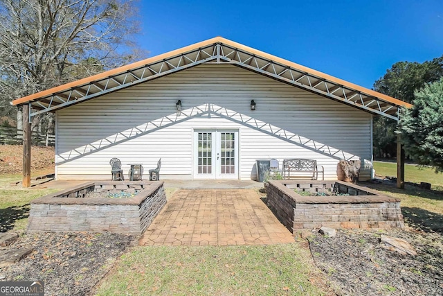 387 Colvin Dr, Locust Grove, GA 30248 - rear view of house with french doors and a patio