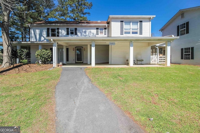 387 Colvin Dr, Locust Grove, GA 30248 - view of front of home with a front lawn, asphalt driveway, and a porch