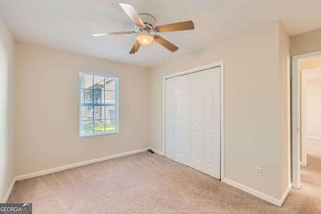 484 Cathedral Dr, Mcdonough, GA 30253 - unfurnished bedroom with light carpet, a closet, baseboards, and a textured ceiling