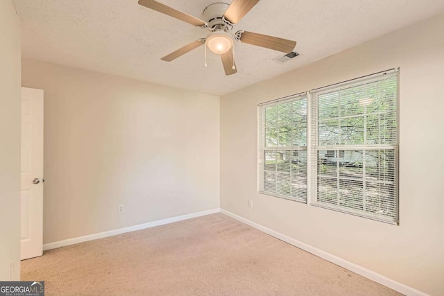 484 Cathedral Dr, Mcdonough, GA 30253 - empty room featuring light carpet, baseboards, ceiling fan, and a textured ceiling