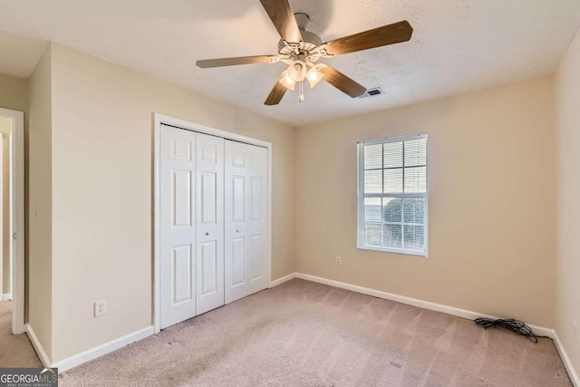 484 Cathedral Dr, Mcdonough, GA 30253 - unfurnished bedroom with carpet, a closet, baseboards, and ceiling fan