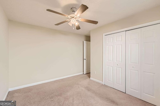 484 Cathedral Dr, Mcdonough, GA 30253 - unfurnished bedroom with carpet, a closet, baseboards, and a ceiling fan