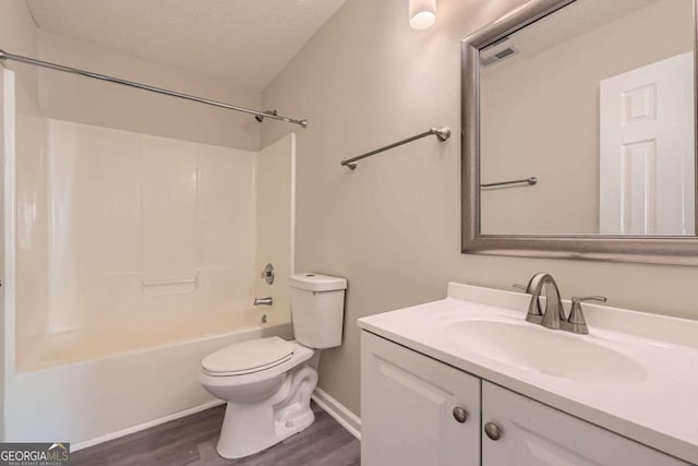 484 Cathedral Dr, Mcdonough, GA 30253 - full bath with wood finished floors, toilet, vanity, a textured ceiling, and  shower combination