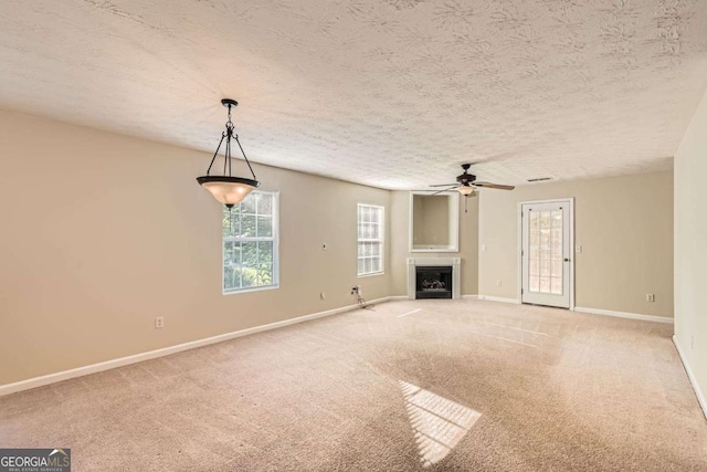 484 Cathedral Dr, Mcdonough, GA 30253 - unfurnished living room with baseboards, a fireplace, carpet flooring, a ceiling fan, and a textured ceiling